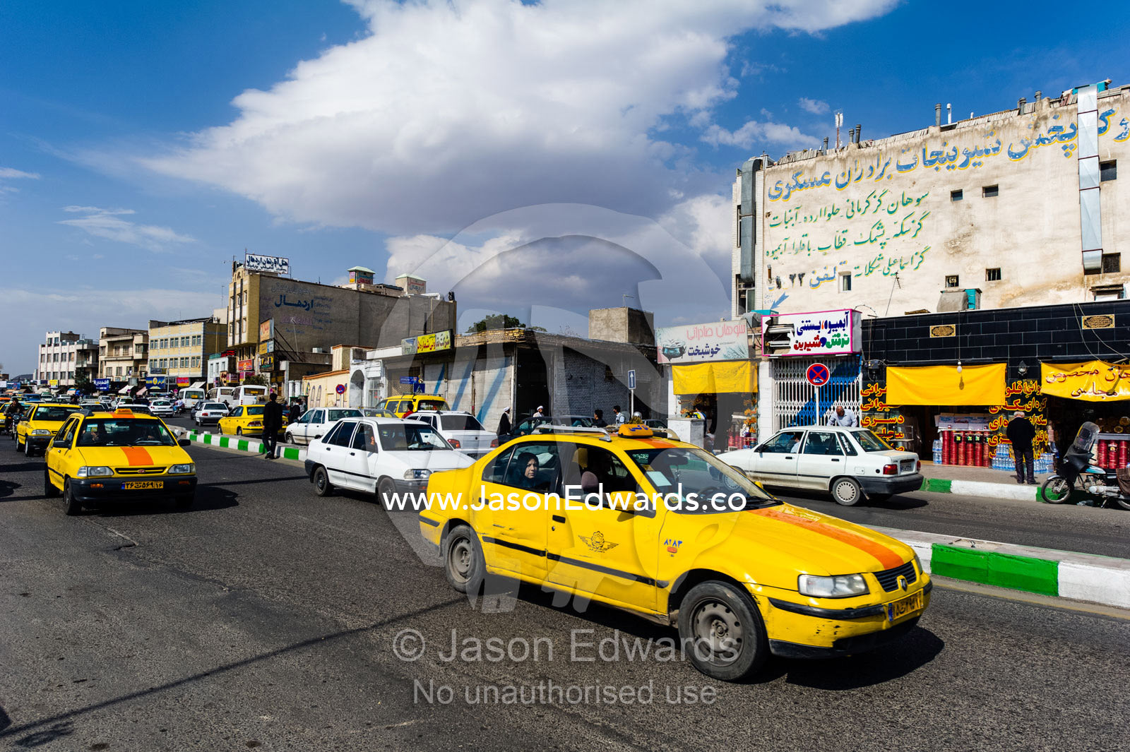 A taxi in the main street of a town during the holiday season. Qom, Qom Province, Islamic Republic of Iran.