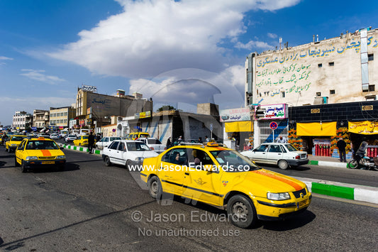 A taxi in the main street of a town during the holiday season. Qom, Qom Province, Islamic Republic of Iran.