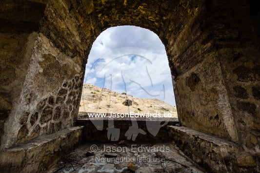An arched doorway of an ancient fire temple looks out onto the desert. Niasar, Neyasar District, Kashan County, Isfahan Province, Islamic Republic of Iran.