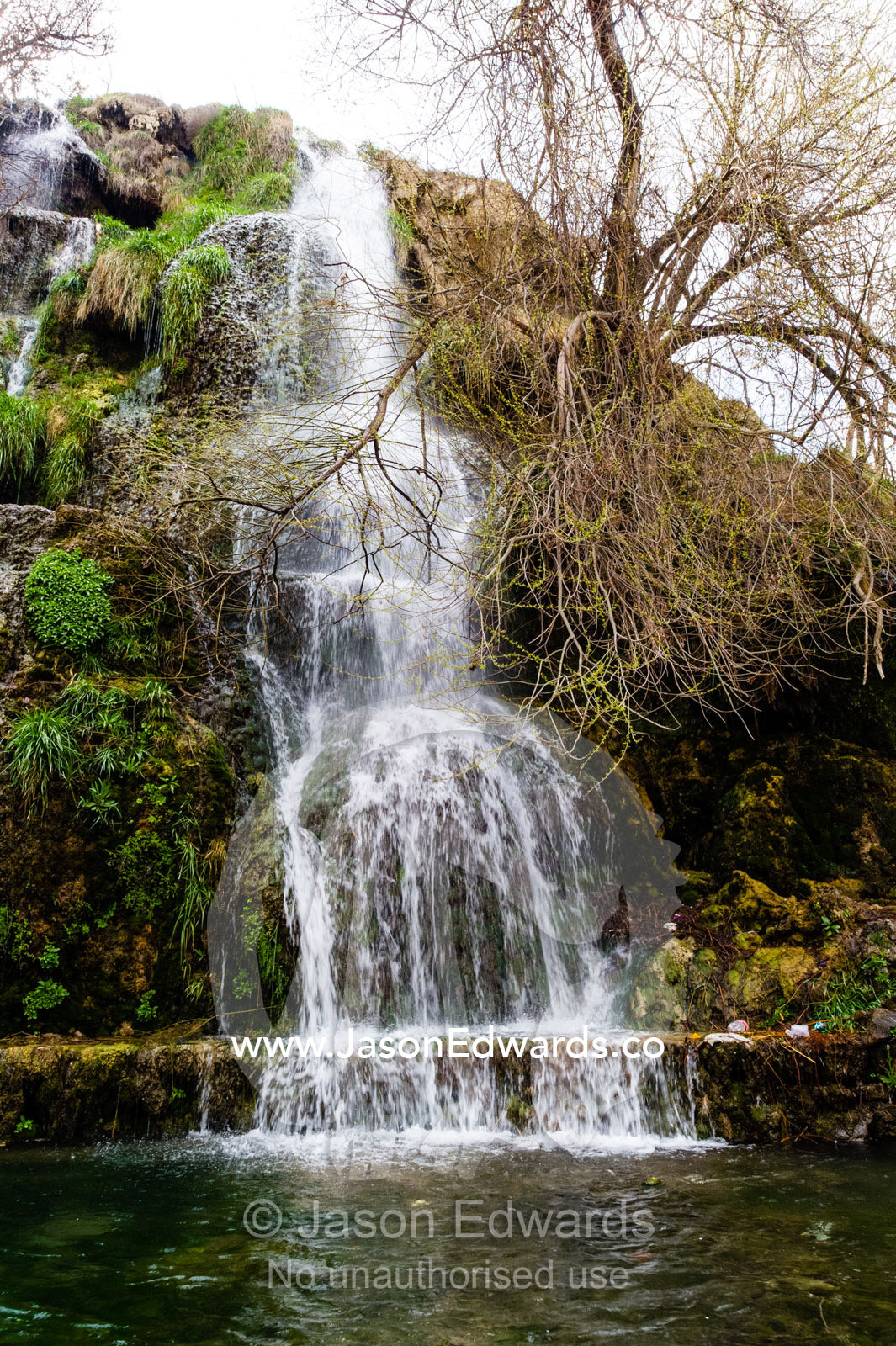 A small waterfall cascades into a mountain pool. Niasar, Neyasar District, Kashan County, Isfahan Province, Islamic Republic of Iran.