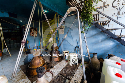 A rose water workshop where rose petals are steeped and distilled in water. Niasar, Neyasar District, Kashan County, Isfahan Province, Islamic Republic of Iran.