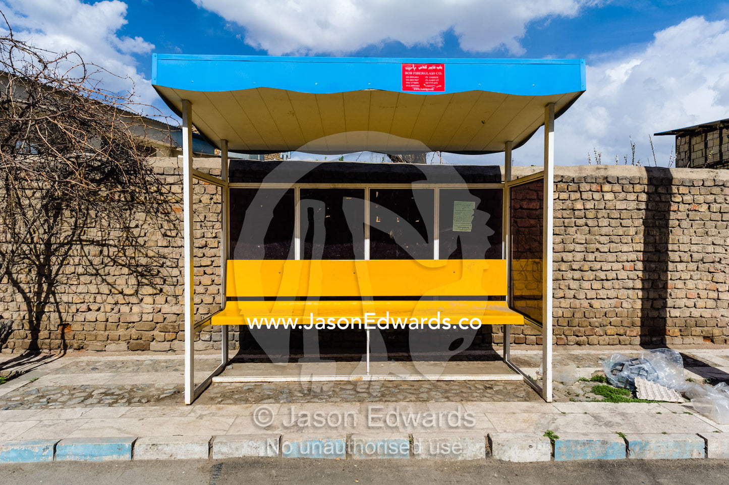 A bright yellow bus stop in a small mountain village. Niasar, Neyasar District, Kashan County, Isfahan Province, Islamic Republic of Iran.