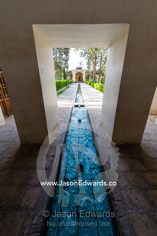 A spring fed water feature running between a row of trees in an historical Persian garden. Fin Garden, Kashan, Isfahan, Islamic Republic of Iran.
