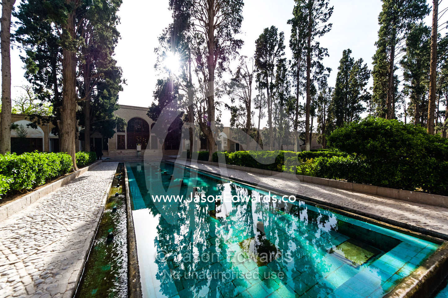 A spring fed water feature running between a row of trees in an historical Persian garden. Fin Garden, Kashan, Isfahan, Islamic Republic of Iran.
