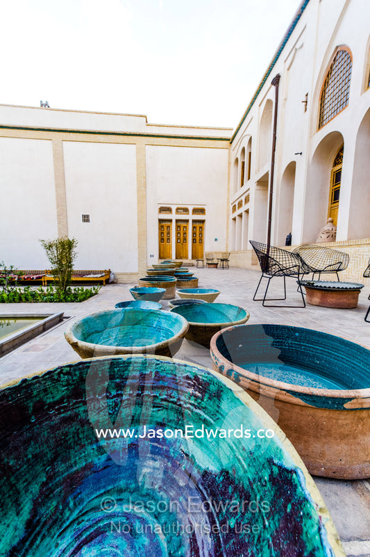 A series of blue-glazed Kashan bowls in a garden. Manuchehri house, Kashan, Isfahan, Islamic Republic of Iran.