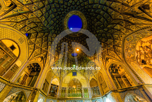 The moon shines through the skylight above the vaulted spiralling geometric ceiling of an ancient bazaar. The Bazaar of Kashan, Kashan, Isfahan, Islamic Republic of Iran.