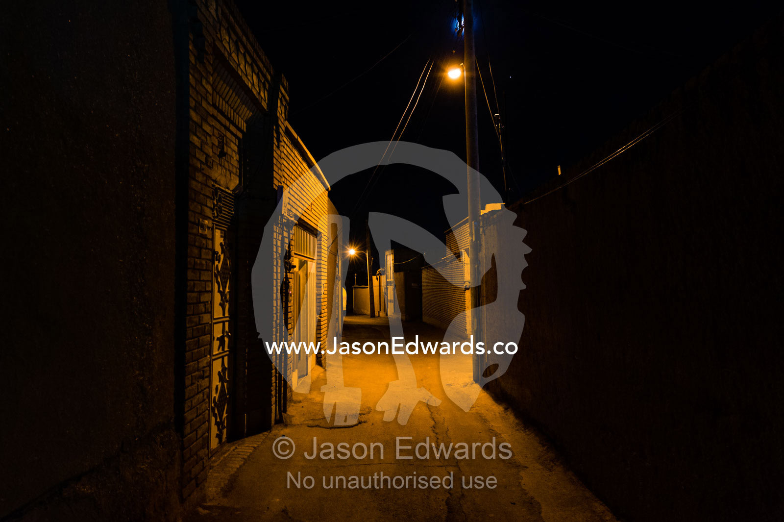 Ancient lanes illuminated by light bulbs in an old neighborhood. Kashan, Isfahan, Islamic Republic of Iran.