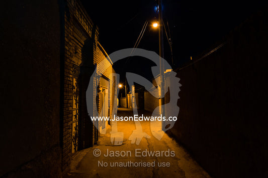 Ancient lanes illuminated by light bulbs in an old neighborhood. Kashan, Isfahan, Islamic Republic of Iran.