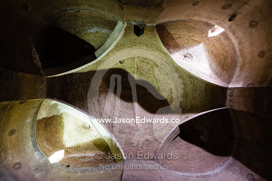 The towering brick walls and domed ceilings of an ancient grainery. Kashan, Isfahan, Islamic Republic of Iran.