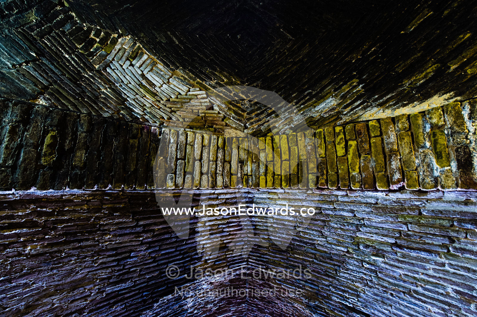 Handmade bricks line an arched tunnel descending to an ancient underground city used for defense. Ouyi, Noushabad, Kashan, Isfahan province, Islamic Republic of Iran.