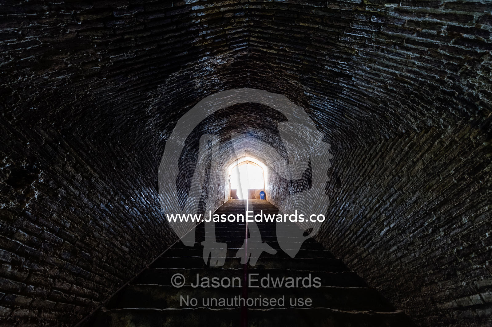 Handmade bricks line an arched tunnel and stairwell descending to an ancient underground city used for defense. Ouyi, Noushabad, Kashan, Isfahan province, Islamic Republic of Iran.