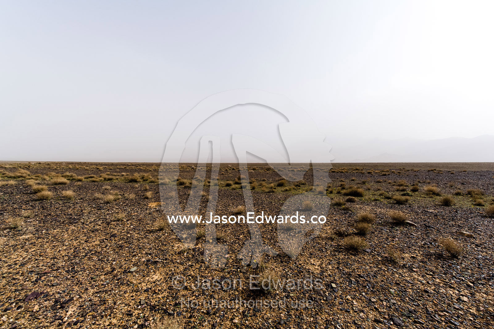 A misty morning over a barren gravel desert. Barzrud Rural District, Natanz County, Isfahan Province, Islamic Republic of Iran.