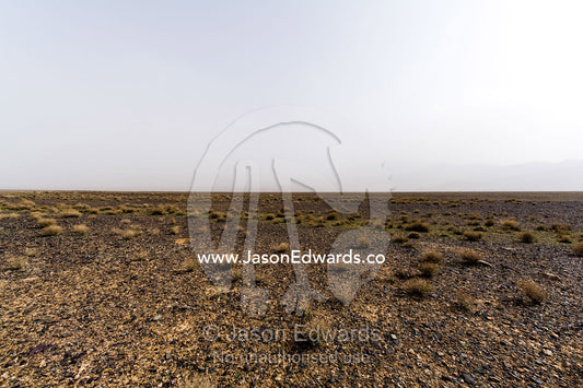 A misty morning over a barren gravel desert. Barzrud Rural District, Natanz County, Isfahan Province, Islamic Republic of Iran.
