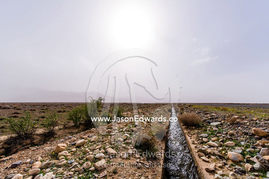 An aqueduct known as a falaj transports water across a barren desert. Barzrud Rural District, Natanz County, Isfahan Province, Islamic Republic of Iran.