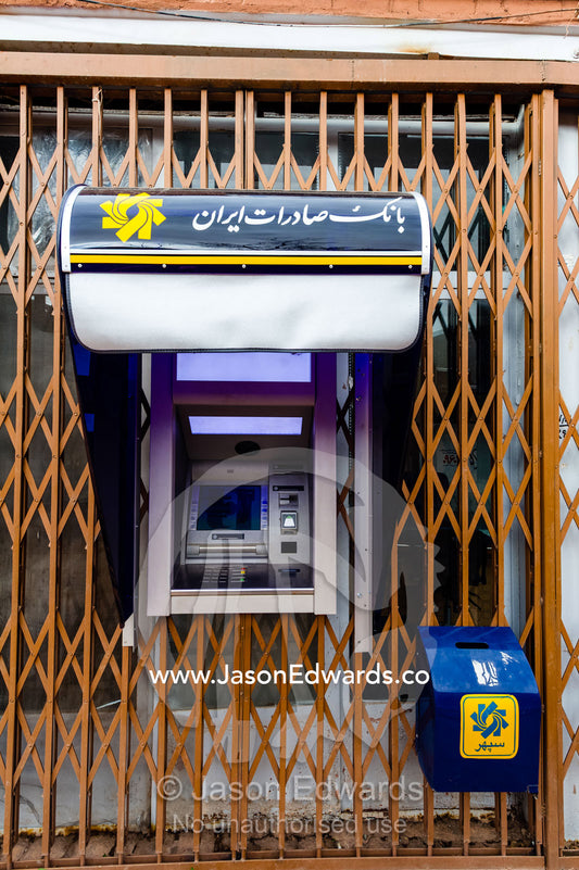 An ATM banking outlet surrounded by steel bars in a village. Abyaneh Village, Abyaneh, Barzrud Rural District, Natanz County, Isfahan Province, Islamic Republic of Iran.