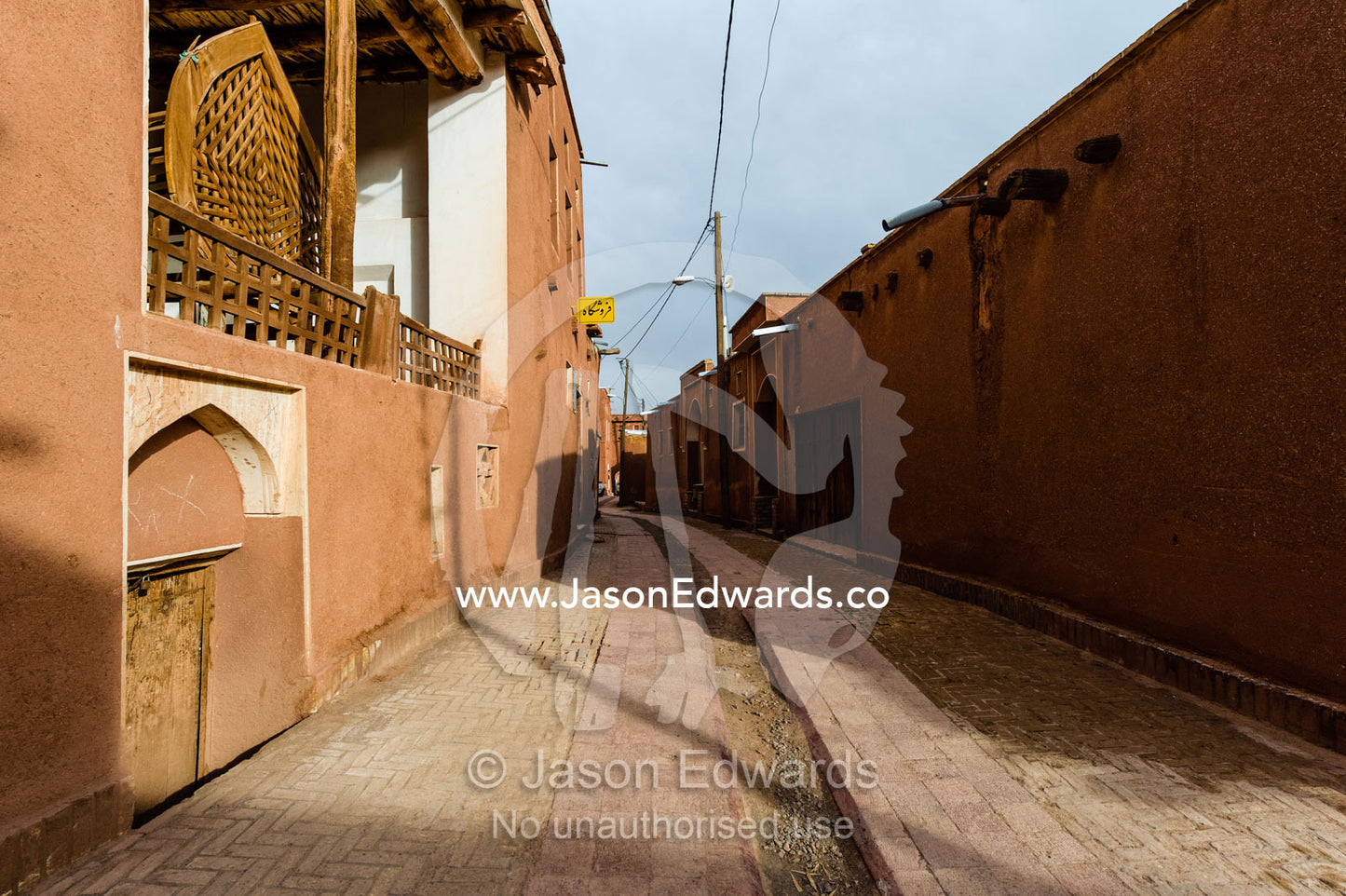 Red ochre houses line a street in a quiet mountain village. Abyaneh Village, Abyaneh, Barzrud Rural District, Natanz County, Isfahan Province, Islamic Republic of Iran.