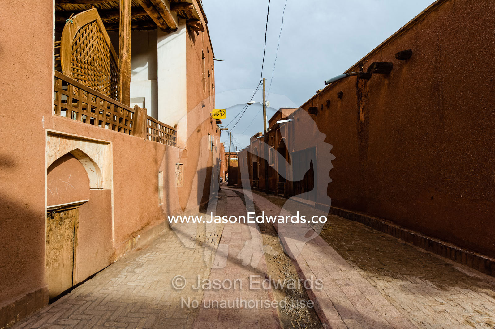 Red ochre houses line a street in a quiet mountain village. Abyaneh Village, Abyaneh, Barzrud Rural District, Natanz County, Isfahan Province, Islamic Republic of Iran.
