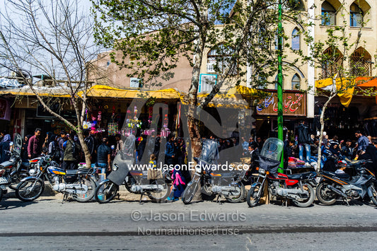 Motorbikes lined up along a street market. Isfahan, Isfahan Province, Islamic Republic of Iran.