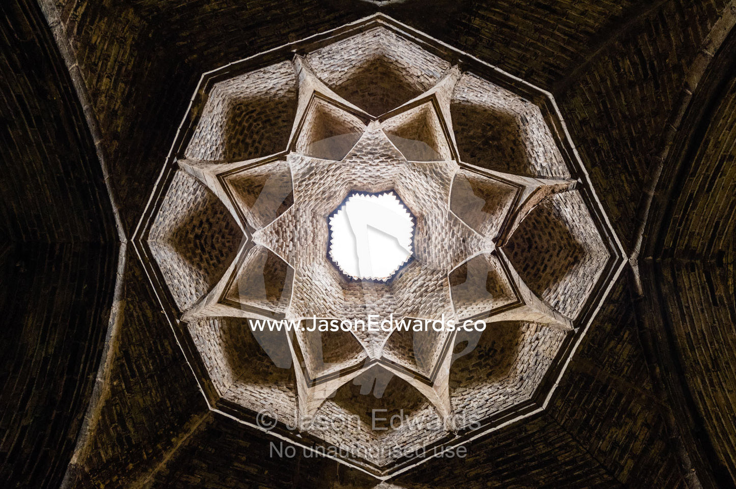 The geometric petals and skylight of a vaulted ceiling in Jameh Mosque. Jameh Mosque of Isfahan, Isfahan, Isfahan Province, Islamic Republic of Iran.