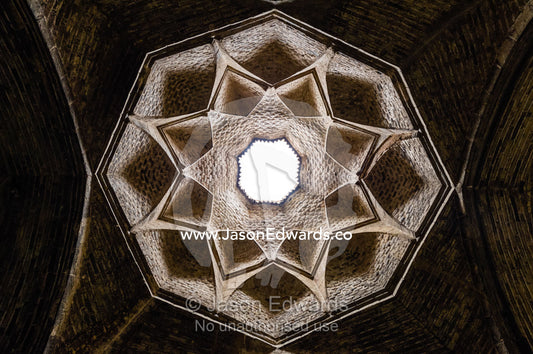 The geometric petals and skylight of a vaulted ceiling in Jameh Mosque. Jameh Mosque of Isfahan, Isfahan, Isfahan Province, Islamic Republic of Iran.