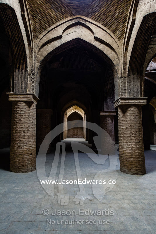 Enormous stone columns of handmade bricks supporting the dome ceilings of the Jameh Mosque. Jameh Mosque of Isfahan, Isfahan, Isfahan Province, Islamic Republic of Iran.