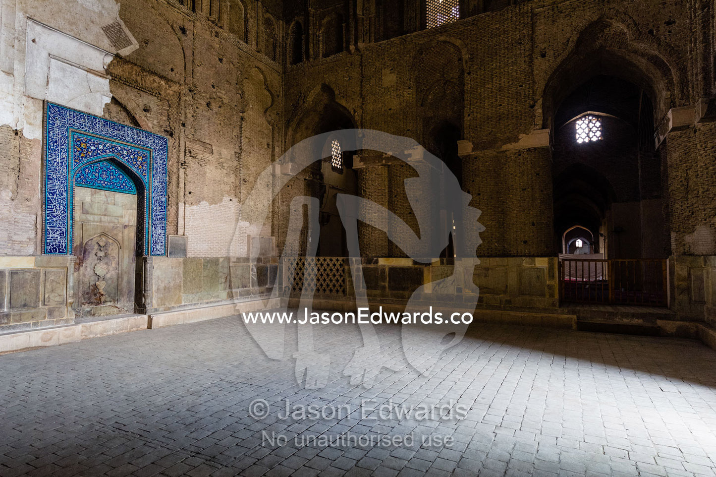 Daylight illuminates the vast intereios of the Jameh Mosque through a doorway. Jameh Mosque of Isfahan, Isfahan, Isfahan Province, Islamic Republic of Iran.