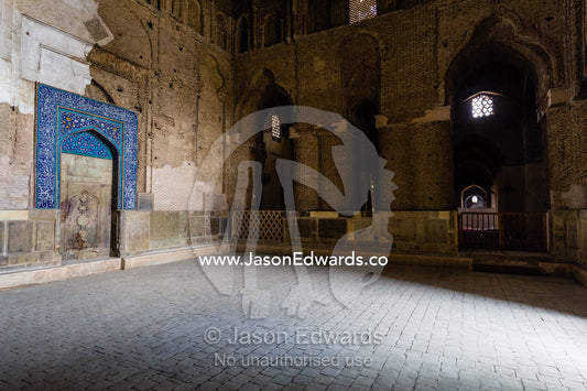 Daylight illuminates the vast intereios of the Jameh Mosque through a doorway. Jameh Mosque of Isfahan, Isfahan, Isfahan Province, Islamic Republic of Iran.