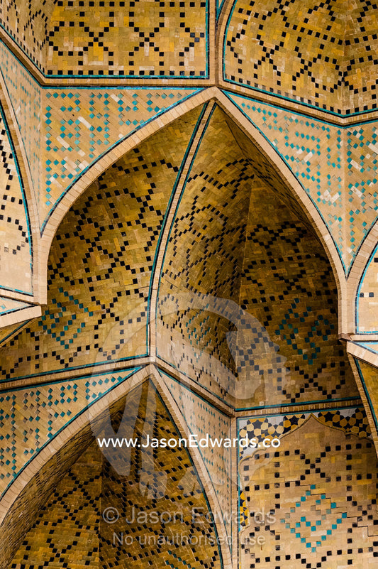 The intricate tiled muqarnas on the vaulted surface of the iwan of Jameh Mosque. Jameh Mosque of Isfahan, Isfahan, Isfahan Province, Islamic Republic of Iran.