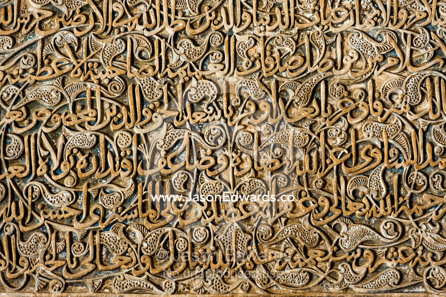 A mix of calligraphy featuring Arabic writing from the Qoran in gypsum stucco and design of flowers. Jameh Mosque of Isfahan, Isfahan, Isfahan Province, Islamic Republic of Iran.
