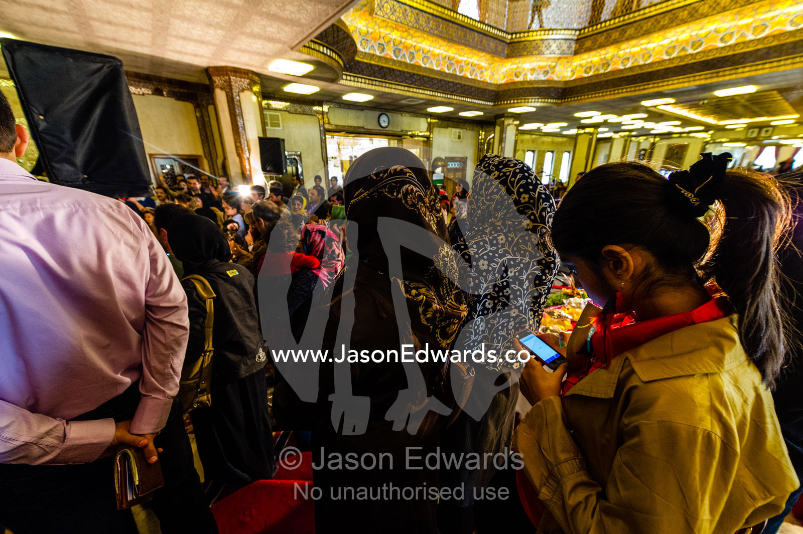 A teenage girl sends text messages on her cell phone at an Iranian New Year party Nowruz. The Abbasi Hotel, Isfahan, Isfahan Province, Islamic Republic of Iran.