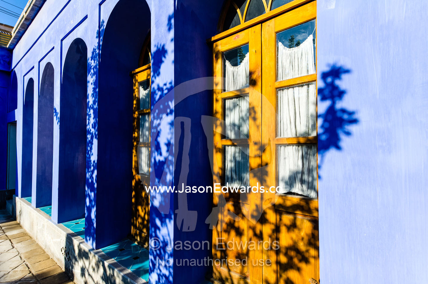 Leave shadows on a bright purple wall in the sunny courtyard of a traditional house. Dibai house, Isfahan, Isfahan Province, Islamic Republic of Iran.