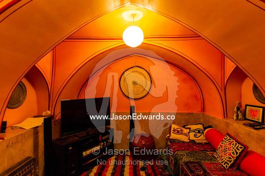 A television in a bright orange living room in a traditional house. Dibai house, Isfahan, Isfahan Province, Islamic Republic of Iran.