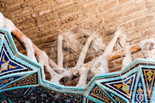 The internal structure of intricate tiled muqarnas on the vaulted surface of the iwan during renovation. Isfahan, Isfahan Province, Islamic Republic of Iran.