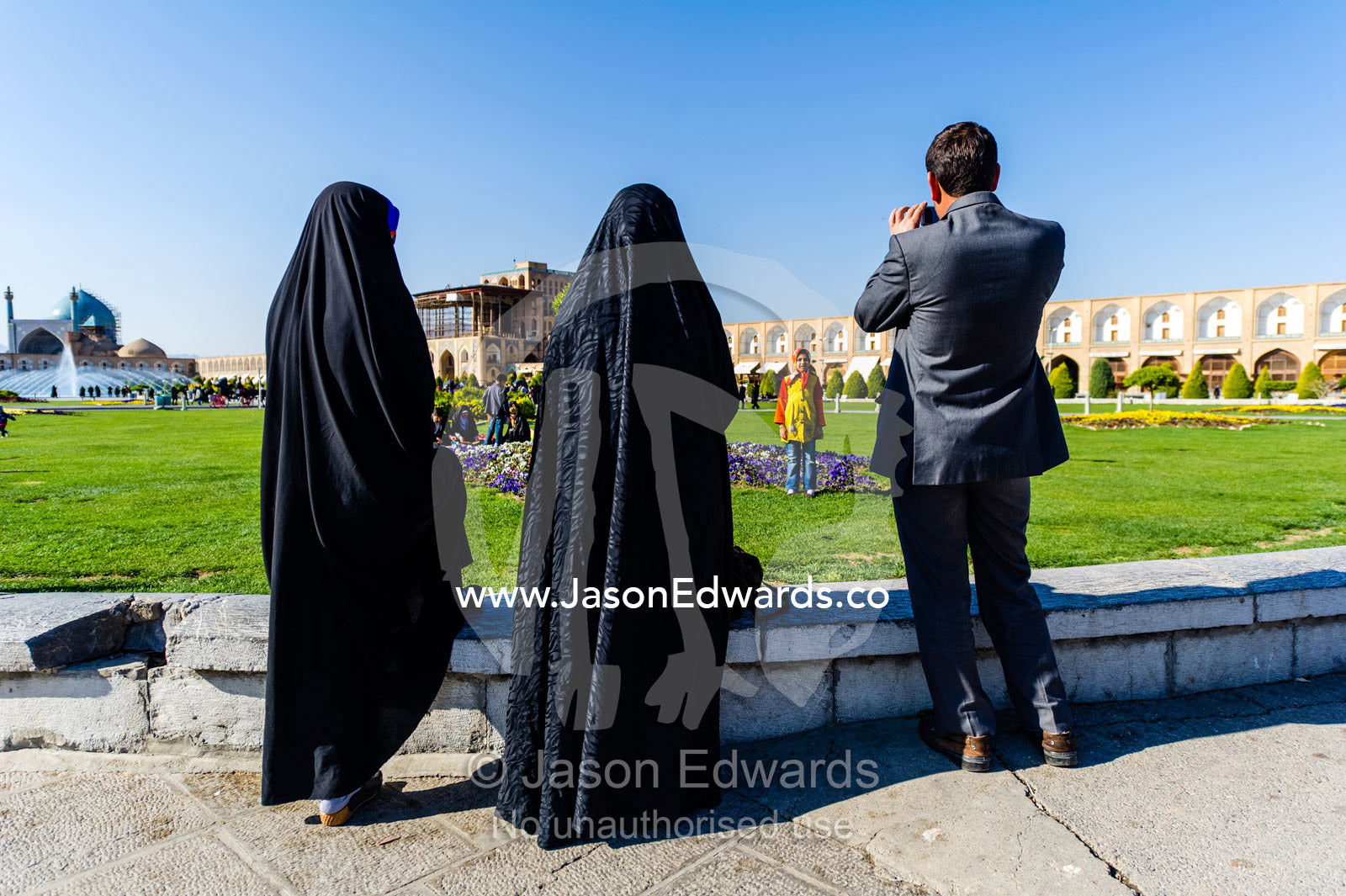 A man takes a photo of his family whilst on holidays in Naqsh-e Jahan Square. Naqsh-e Jahan Square, Isfahan, Isfahan Province, Islamic Republic of Iran.