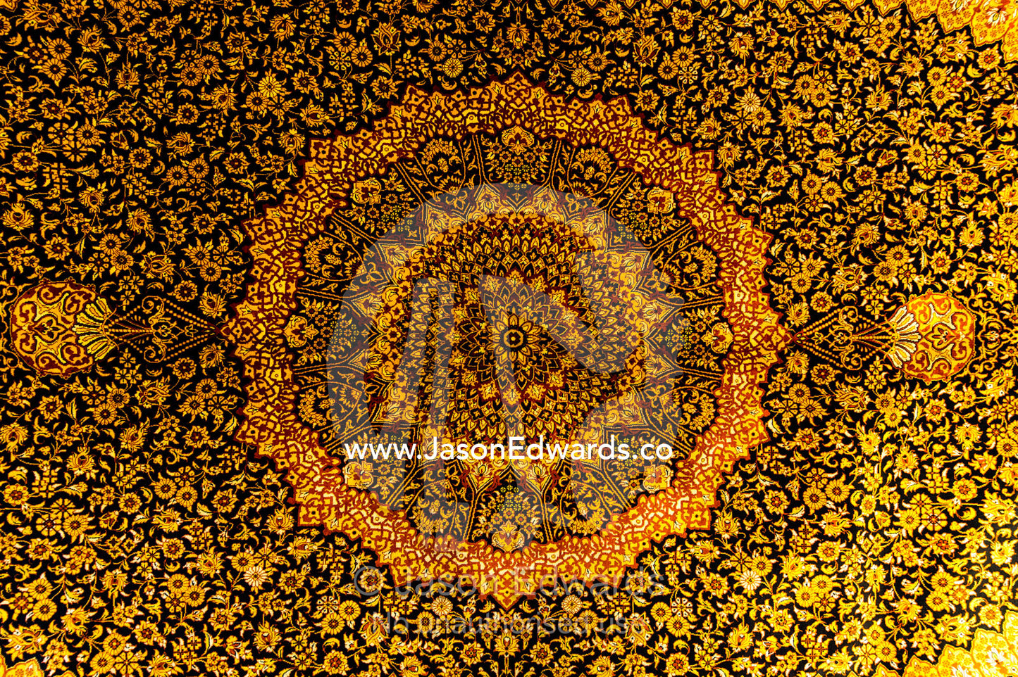 The intricate detail of a golden yellow Persian carpet. Isfahan, Isfahan Province, Islamic Republic of Iran.