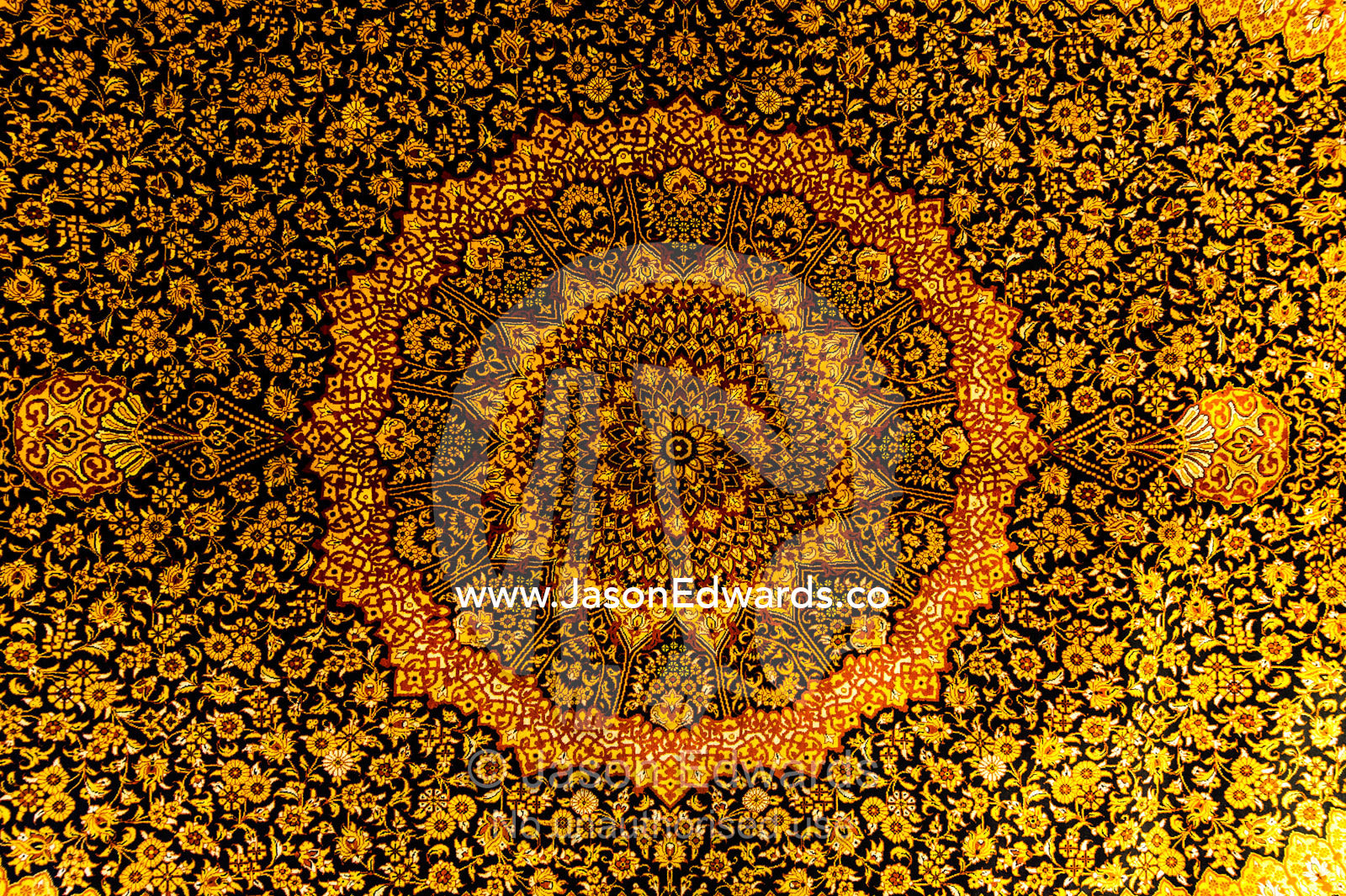 The intricate detail of a golden yellow Persian carpet. Isfahan, Isfahan Province, Islamic Republic of Iran.