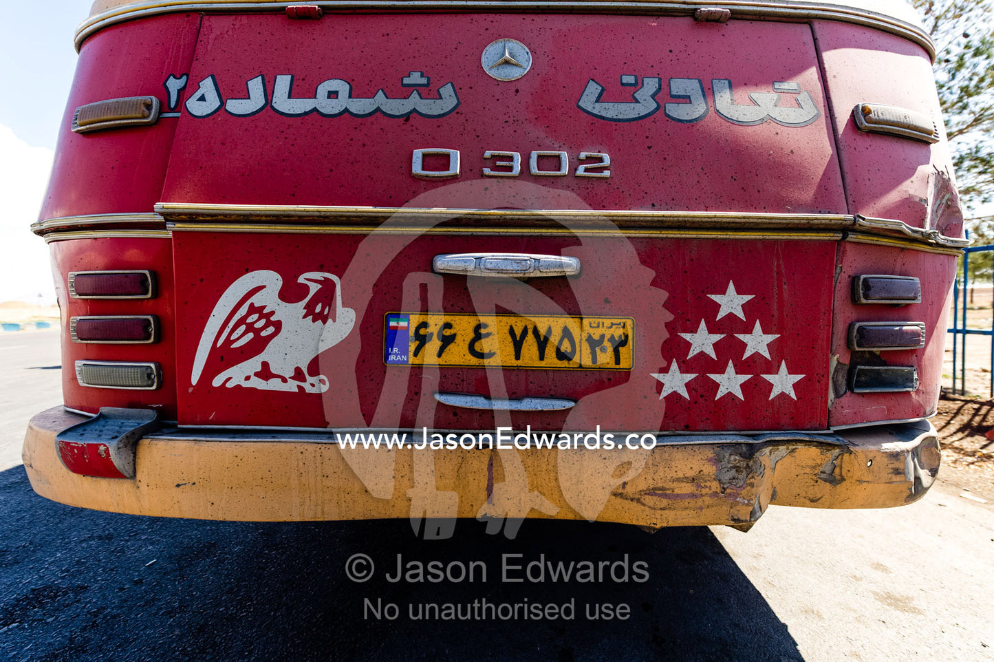 Stencil art of an eagle and stars on the back of an old public bus. Isfahan, Isfahan Province, Islamic Republic of Iran.