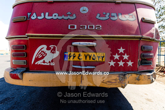 Stencil art of an eagle and stars on the back of an old public bus. Isfahan, Isfahan Province, Islamic Republic of Iran.
