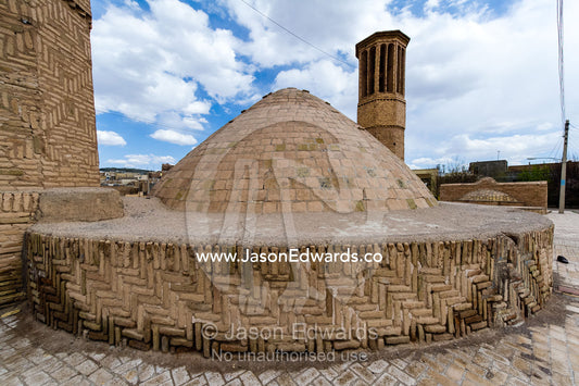 The dome ceiling of an ancient cistern and a windcatcher in a village. Nain, Nain County, Isfahan Province, Iran.