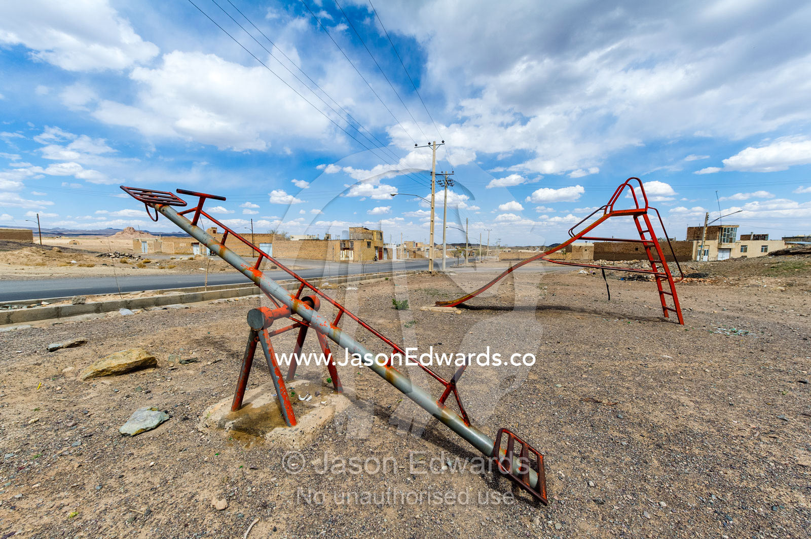 A derelict slide and seesaw in a desert village. Nain, Nain County, Isfahan Province, Iran.
