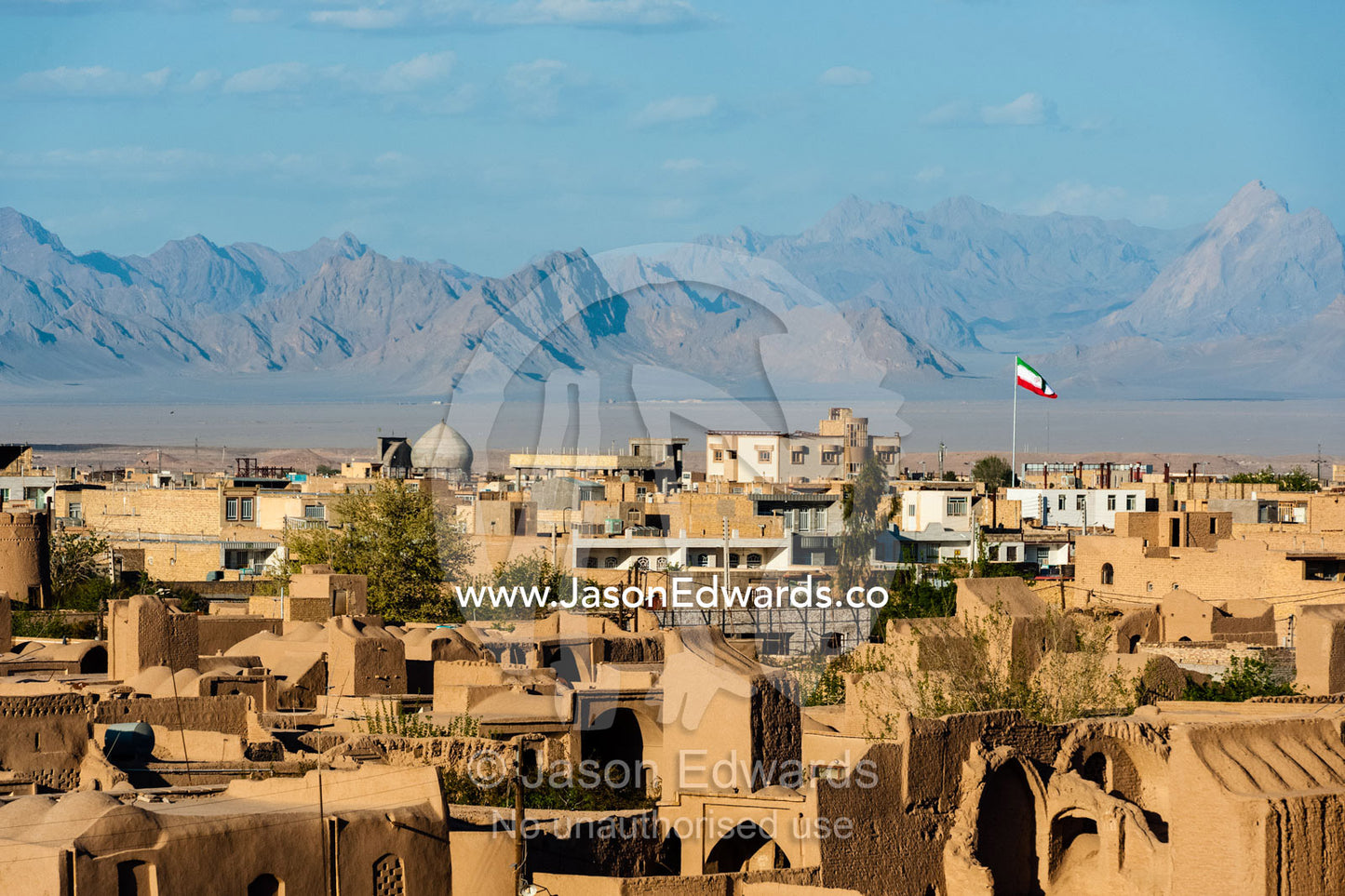 The redochre rooftops of Meybod sprawling across the desert plain. Meybod, Meybod County, Yazd Province, Islamic Republic of Iran.