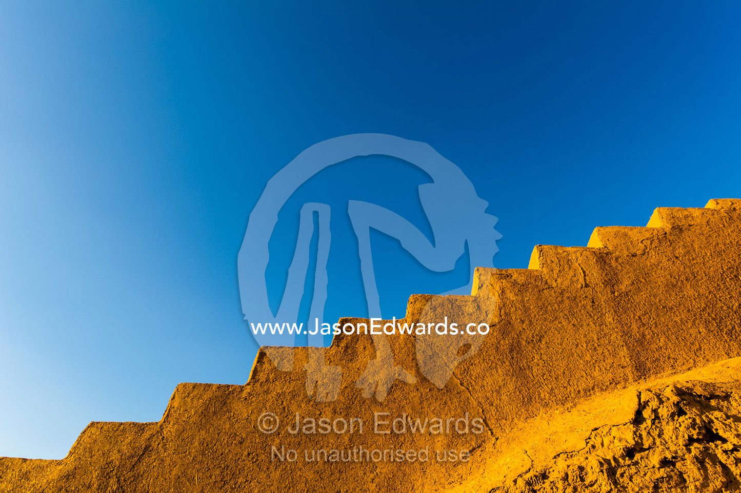 Ancient mud brick stairs in a desert fortress against a blue sky. Narin Castle, Meybod, Meybod County, Yazd Province, Islamic Republic of Iran.
