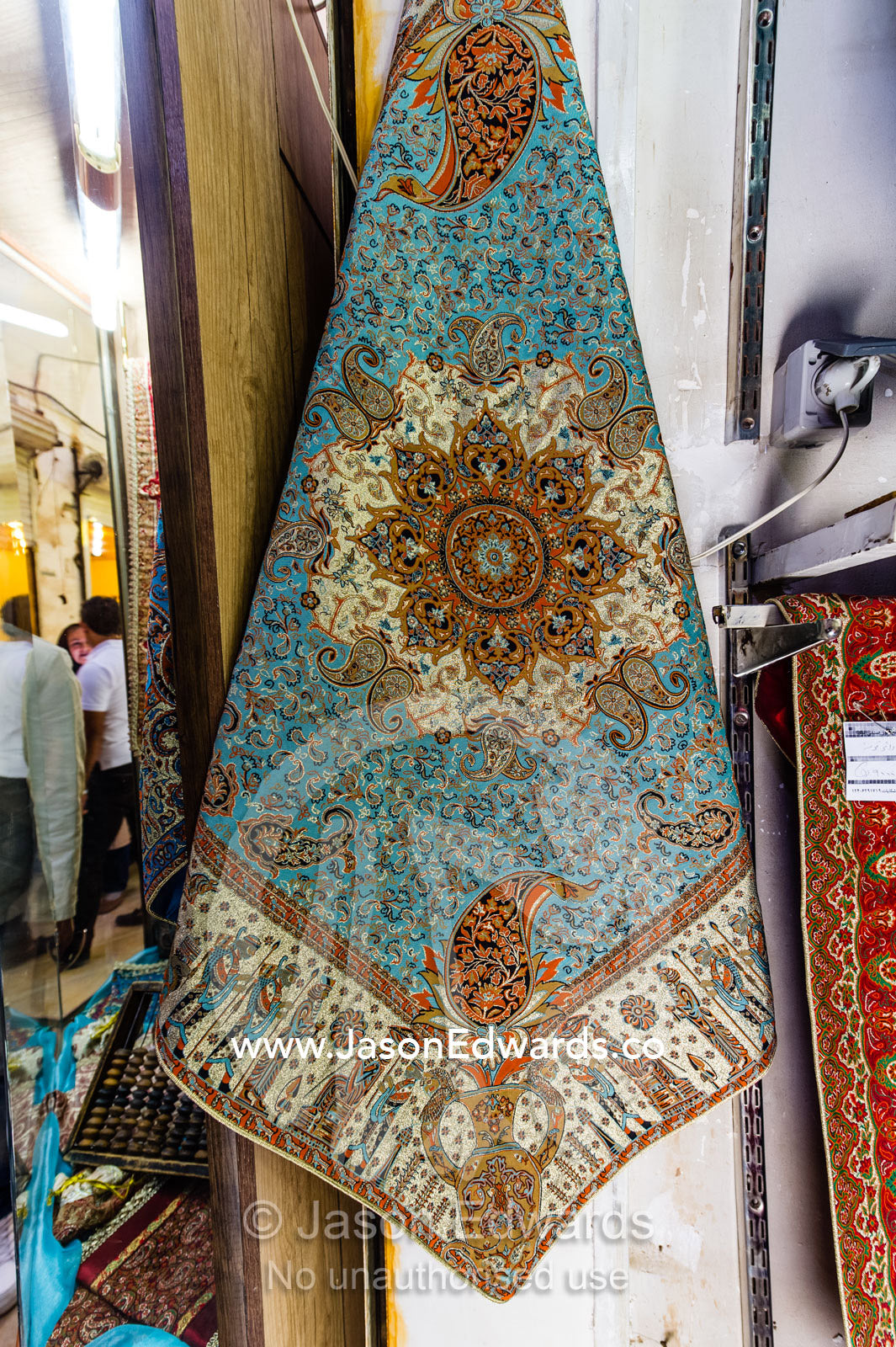 A shop in a bazaar selling termeh fabric an intricate and delicate cloth. Yazd, Yazd Province, Islamic Republic of Iran.