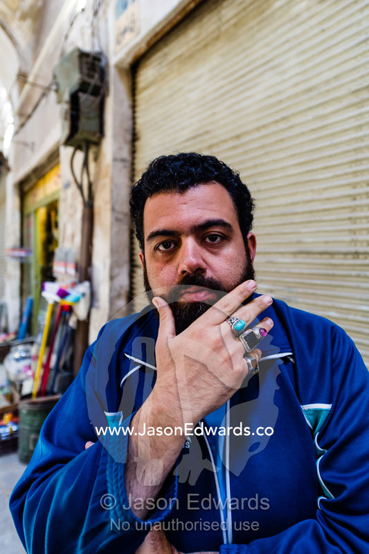 A merchant displays his silver and precious stone rings he sells in a bazaar. Yazd, Yazd Province, Islamic Republic of Iran.