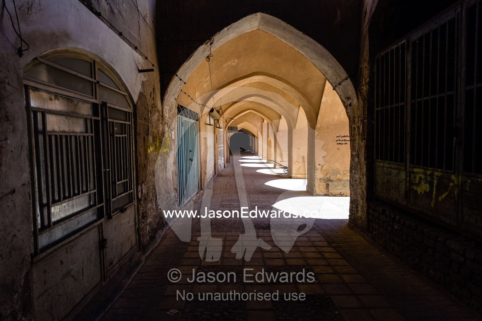 The vaulted ceiling of an ancient bazaar where shops are closed the a public holiday. Yazd, Yazd Province, Islamic Republic of Iran.