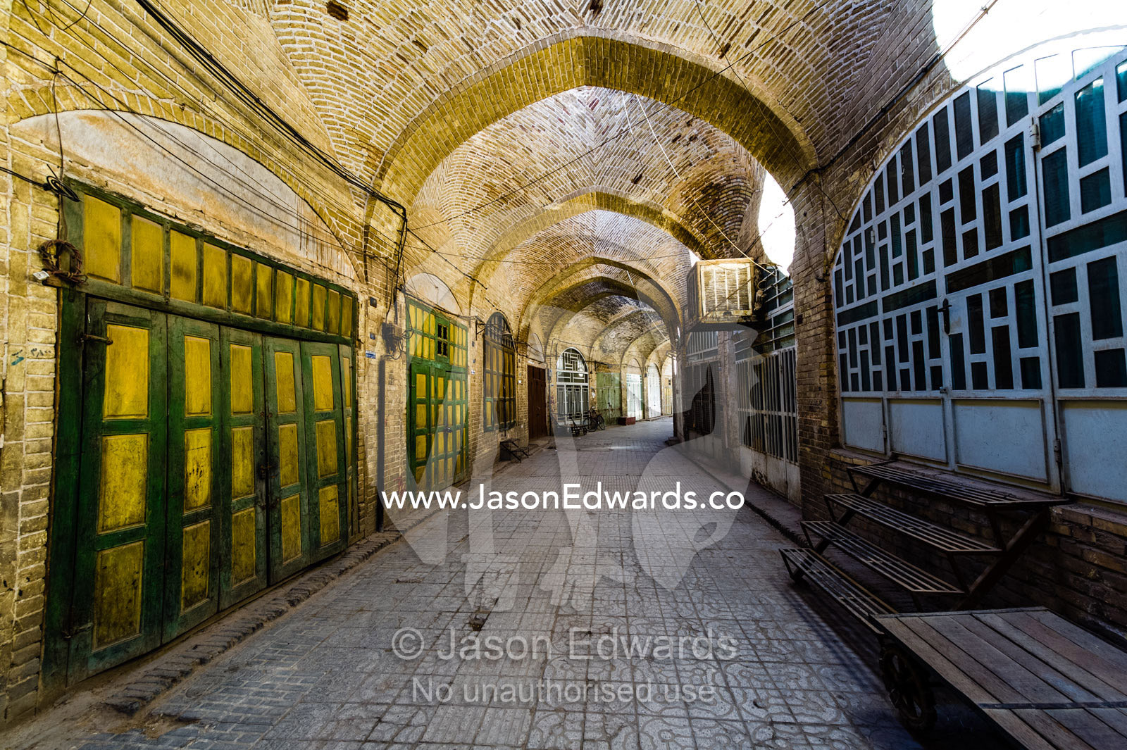 The vaulted ceiling of an ancient bazaar where shops are closed the a public holiday. Yazd, Yazd Province, Islamic Republic of Iran.