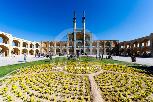 The towering minarets and iwans of Amir Chakhmaq Mosque overlook flower gardens in the square. Amir Chakhmaq Square, Yazd, Yazd Province, Islamic Republic of Iran.