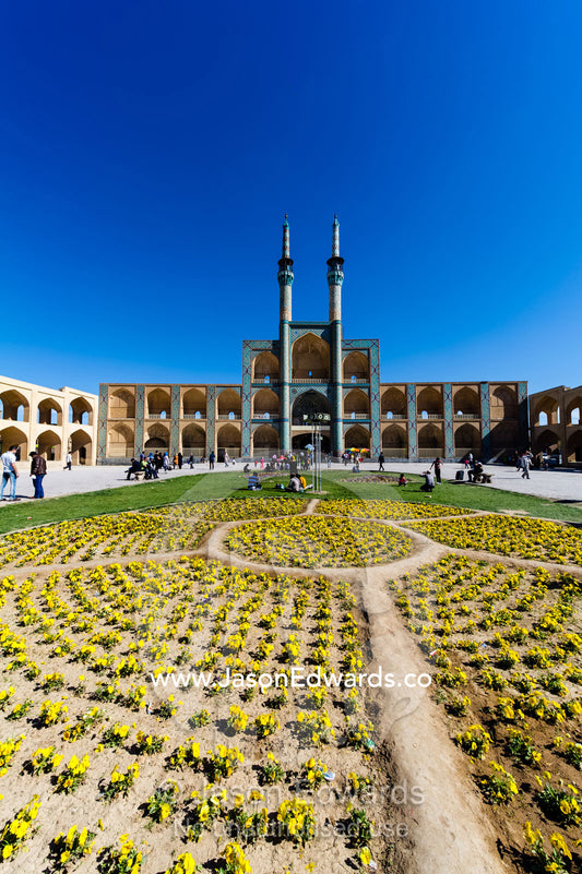 The towering minarets and iwans of Amir Chakhmaq Mosque overlook flower gardens in the square. Amir Chakhmaq Square, Yazd, Yazd Province, Islamic Republic of Iran.