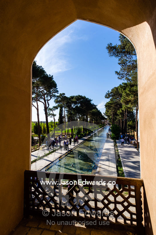Looking through an arched balcony along a traditional garden pond. Dowlat Abad Garden, Yazd, Yazd Province, Islamic Republic of Iran.