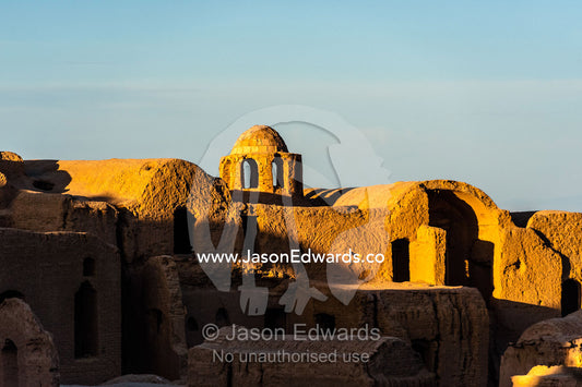 Looking across the rooftops of crumbling handmade brick ruins of an ancient abandoned village in the desert. Kharanagh, Yazd, Yazd Province, Islamic Republic of Iran.